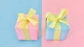 Pink and blue gift boxes ribbon bow on pink and blue background. Royalty Free Stock Photo