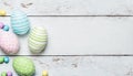 Pink, blue, green eggs border for Easter card, minimal concept. Easter left corner border made of colored eggs lay on white wooden Royalty Free Stock Photo