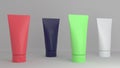 Pink, blue, green and gray tubes without logos and inscriptions on a gray background