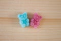 Pink and blue jelly gummy bear on wooden background. Royalty Free Stock Photo