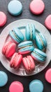 Pink and blue macarons elegantly arranged on white plate, complimentary