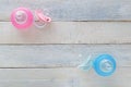 Pink and Blue pacifiers and baby bottles on white wood Royalty Free Stock Photo