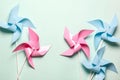 Pink blue paper spinners on light background. Kids toys colorful pinwheels on celebration party background. Top view Royalty Free Stock Photo