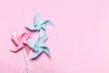 Pink blue paper spinners on light pink background. Kids toys colorful pinwheels on celebration party background. Top Royalty Free Stock Photo