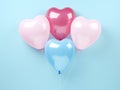 a pink and blue pink and blue balloon has four hearts on it