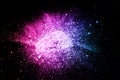 Pink blue powder explosion on black background.Pink blue dust splash cloud on dark background Royalty Free Stock Photo