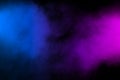 Pink blue powder explosion on black background.Pink blue dust splash cloud on dark background Royalty Free Stock Photo