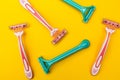 Pink and blue razors for women on a yellow background Royalty Free Stock Photo