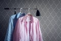 Pink and blue shirts on wallpaper background Royalty Free Stock Photo