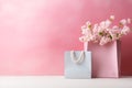 Pink and blue shopping bags with flower on pink background, eleglance springtime or summer sale and Valentine surprise offer