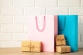 Pink and blue shopping bags with gift on light background. Black friday Royalty Free Stock Photo