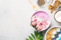 Pink and blue smoothie in bowl with pitaya, strawberry and raspberry