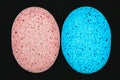 Pink and blue sponge on black background surface Royalty Free Stock Photo