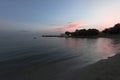 Pink and blue sunset on the beach in Creta, Greece. A beach with blacks rocks and waves at dusk Royalty Free Stock Photo