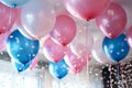 Pink, blue and white balloons, confetti and streamers as a decorations at a gender reveal or a baby shower party Royalty Free Stock Photo