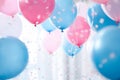 Pink, blue and white balloons, confetti and streamers as a decorations at a gender reveal or a baby shower party Royalty Free Stock Photo