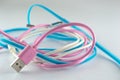 Pink blue and white USB cable on gray background Royalty Free Stock Photo
