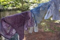 Pink, blue and white woman's thongs are drying on the rope in the summer