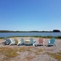 Pink, Blue and Yellow Deck chairs on a Lake shore Royalty Free Stock Photo