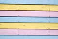 Pink blue and yellow pastel coloured wooden slats