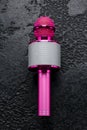 Pink Bluetooth Wireless Karaoke Microphone speaker on black background Royalty Free Stock Photo