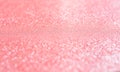 Pink blurred background with highlights and fine texture of shiny crystals