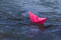 Pink boat floating in the blue water Royalty Free Stock Photo