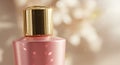 Pink bottle with a glossy finish and a gold metallic cap. The cap is cylindrically Royalty Free Stock Photo