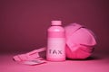 A pink bottle with tax written on it sits on a pink surface. AI generation