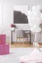 Pink boxes with presents on floor of elegant room ready for birthday hoopla Royalty Free Stock Photo