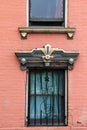 Pink brick wall of home with old,weathered window casings Royalty Free Stock Photo