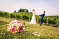 Pink Bridal Bouquet and Newly Weds Holding Hands in the Blurry B Royalty Free Stock Photo