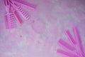 Pink bright comb for hairdressers. Beauty saloon. Tools for hairstyles. Pink background. Barbershop. Set of different hairbrushes