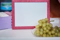 Pink bright frame mock up and grapes close up. Cozy home concept