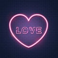 Pink bright vector heart with inscription love, vector neon sign on brick wall. Isolated design element for Valentine`s day. Royalty Free Stock Photo