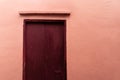 Pink brown door with pink cement wall architecture background