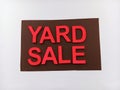 Pink and brown yard sale sign on a white background