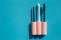 Pink brushes for cosmetics, mascara, liquid lipstick, eyeliner, lip gloss on a blue background Royalty Free Stock Photo