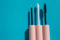 Pink brushes for cosmetics, mascara, liquid lipstick, eyeliner, lip gloss on a blue background Royalty Free Stock Photo