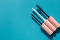 Pink brushes for cosmetics, mascara, liquid lipstick, eyeliner, lip gloss on a blue background Royalty Free Stock Photo