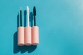 Pink brushes for cosmetics, mascara, liquid lipstick, eyeliner, lip gloss on a blue background Royalty Free Stock Photo