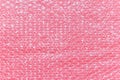 Pink bubble wrap foil on pink backgound