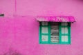 Pink building exterior, vintage wall with closed window and wo Royalty Free Stock Photo