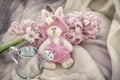 Pink bunnie with small garden watering can, spring flowers. Romantic still life. Gift on Valentin`s, Mothers, Women`s