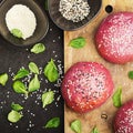 Pink buns for the vegetable Burger on the basis of beet with sesame seeds on dark background. Top view Royalty Free Stock Photo