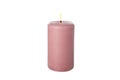 Pink burning candle isolated on background