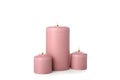 Pink burning candles isolated on background