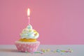 Pink butter-cream cupcake with candle Royalty Free Stock Photo