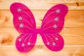 Pink butterfly wings costume for a carnival for a girl on wooden Royalty Free Stock Photo