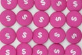 Pink buttons with dollar sign, lined up as background in top view for topics related to finance, business and currencies